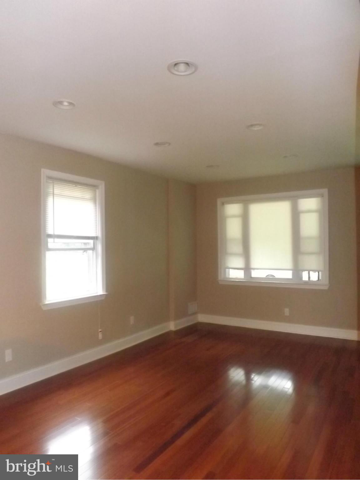 705 St Dunstans Road Baltimore, MD 21212 - Photo 5 of 21 an empty room with wooden floor and windows