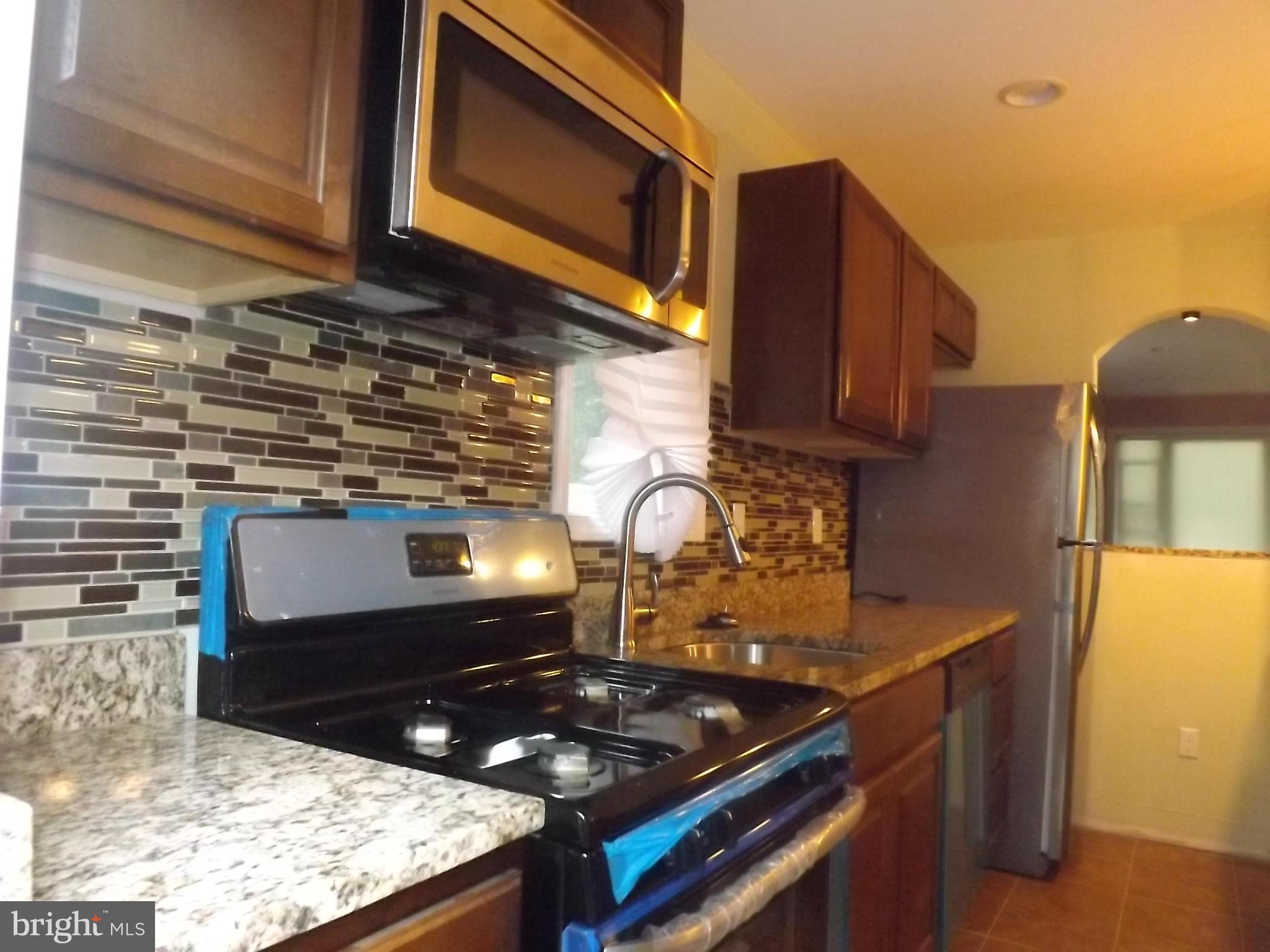 705 St Dunstans Road Baltimore, MD 21212 - Photo 7 of 21 a kitchen with a stove and a microwave
