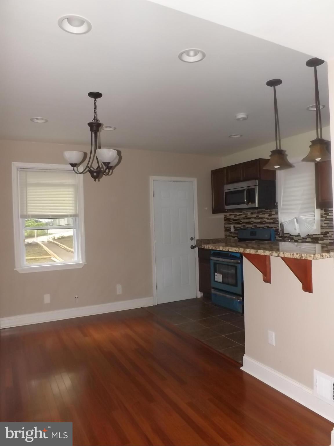 705 St Dunstans Road Baltimore, MD 21212 - Photo 8 of 21 a kitchen with stainless steel appliances granite countertop a stove a sink and a microwave