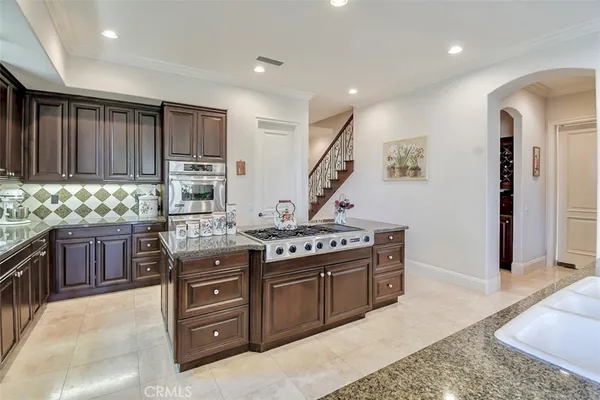 a kitchen with a stove top oven sink and cabinets