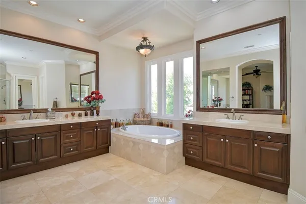 a spacious bathroom with a tub sink shower and mirror