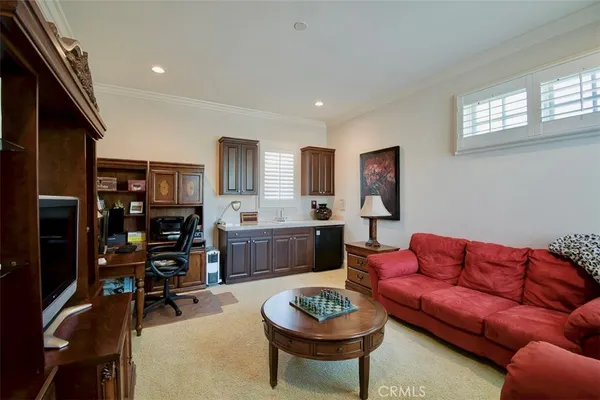 a living room with furniture a rug and a window