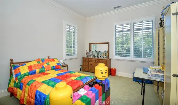 a bedroom with a bed and windows