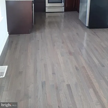 a view of a room with wooden floor