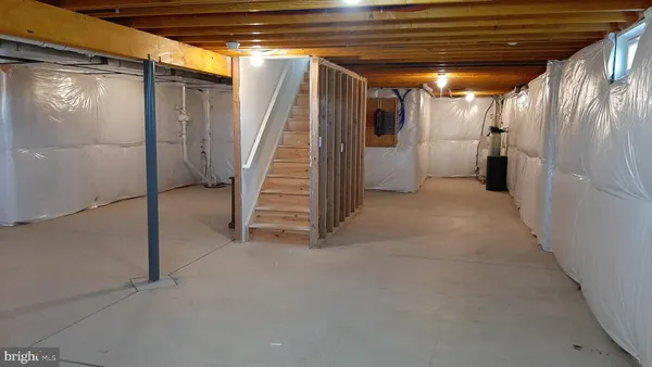 a view of water heater room with stairs
