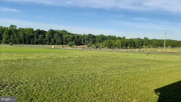 a view of field with trees in the background