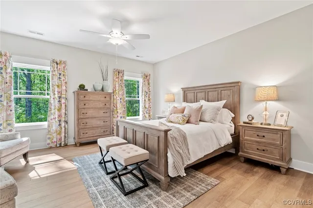 a spacious bedroom with a bed a couch and dresser
