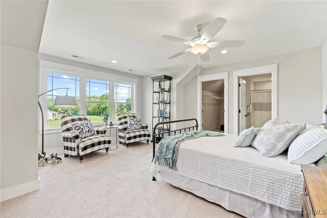 a bedroom with furniture and large windows