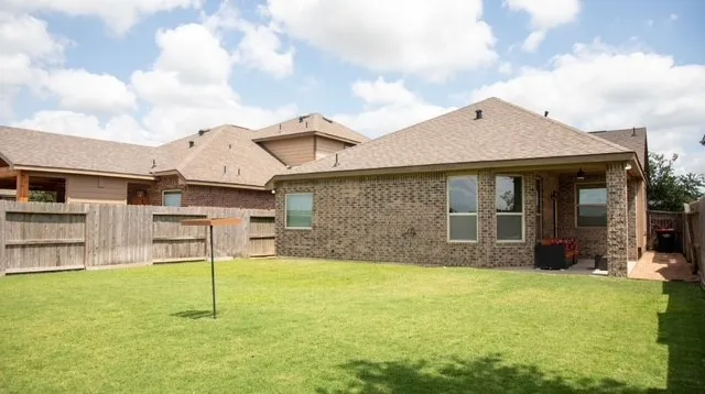 a view of a house with table and chairs in front of it