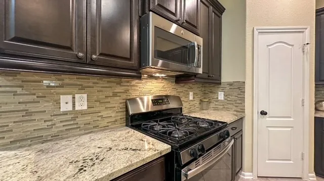 a kitchen with a stove and a microwave