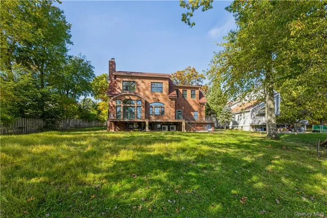 a view of a big yard with large trees
