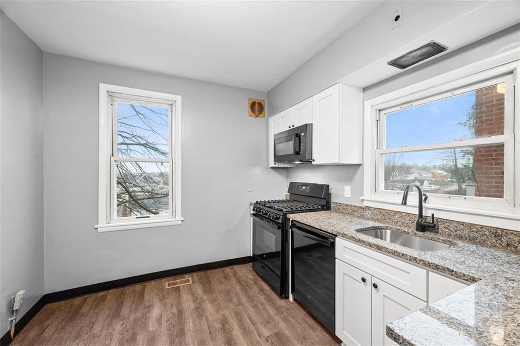 76 Montclair Avenue Pittsburgh, PA 15229 - Photo 12 of 34 a kitchen with stainless steel appliances granite countertop a sink a stove a microwave a refrigerator and cabinets