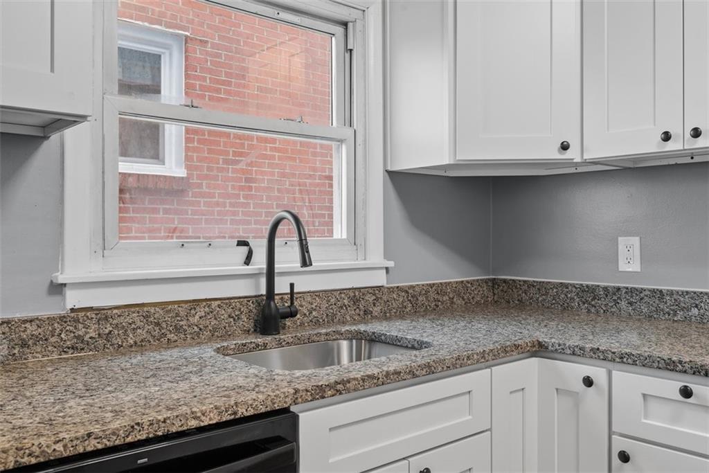 76 Montclair Avenue Pittsburgh, PA 15229 - Photo 13 of 34 a kitchen with granite countertop a sink and cabinets
