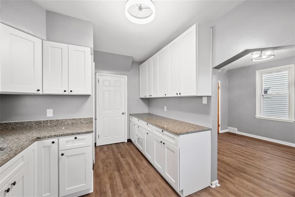 76 Montclair Avenue Pittsburgh, PA 15229 - Photo 15 of 34 a kitchen with granite countertop white cabinets and white appliances