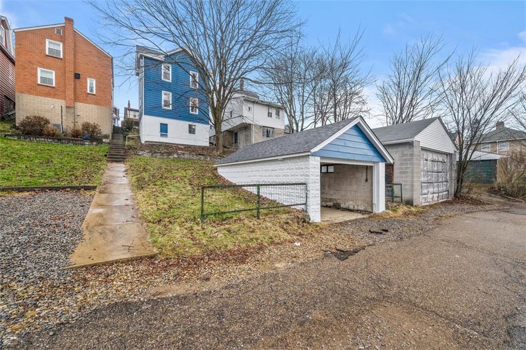 76 Montclair Avenue Pittsburgh, PA 15229 - Photo 29 of 34 a front view of a house with a yard and garage