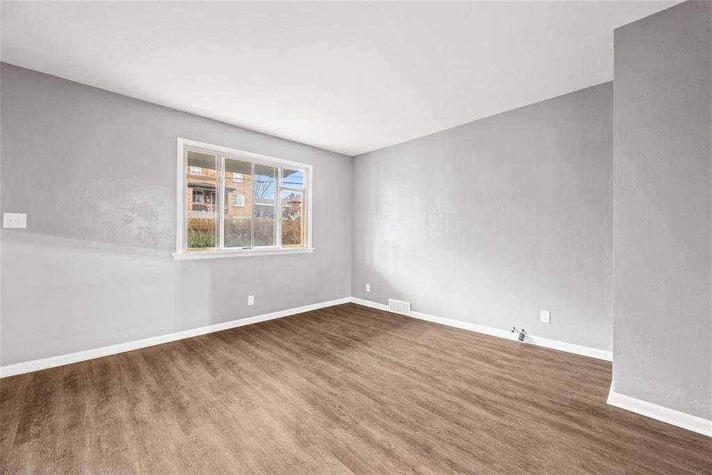 76 Montclair Avenue Pittsburgh, PA 15229 - Photo 6 of 34 an empty room with wooden floor and windows