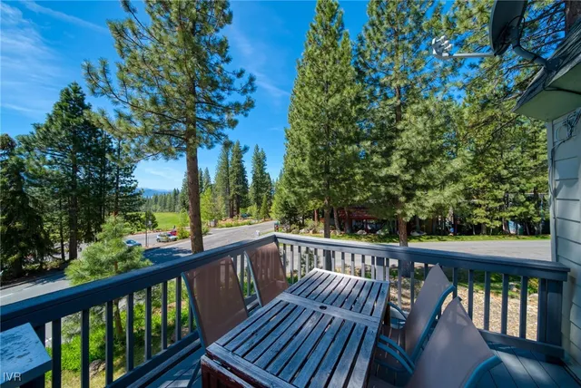 a view of a balcony with wooden floor and fence