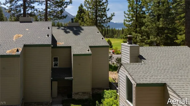 an aerial view of a house with a yard