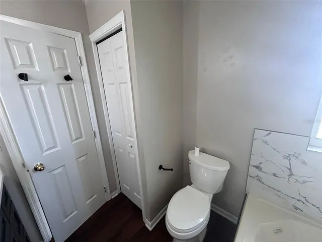 a white toilet sitting next to a sink