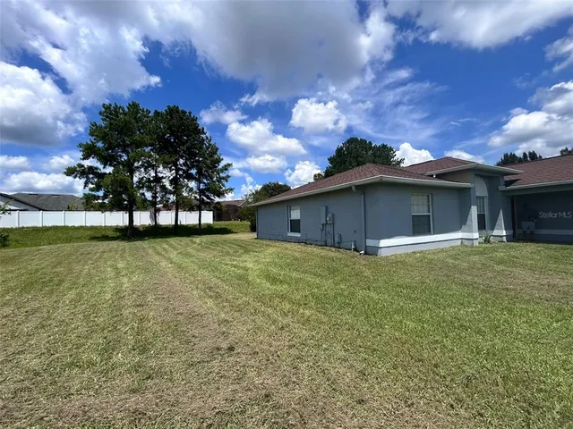 a view of a house with a back yard