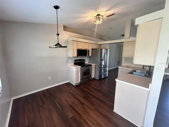 a room with wooden floor and ceiling fan