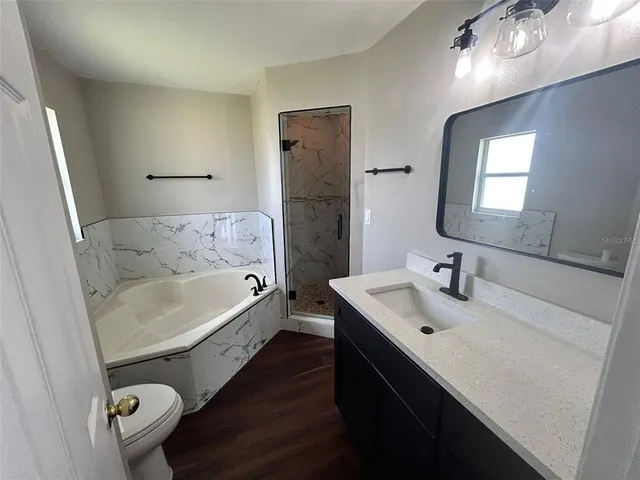 a bathroom with a tub sink and mirror