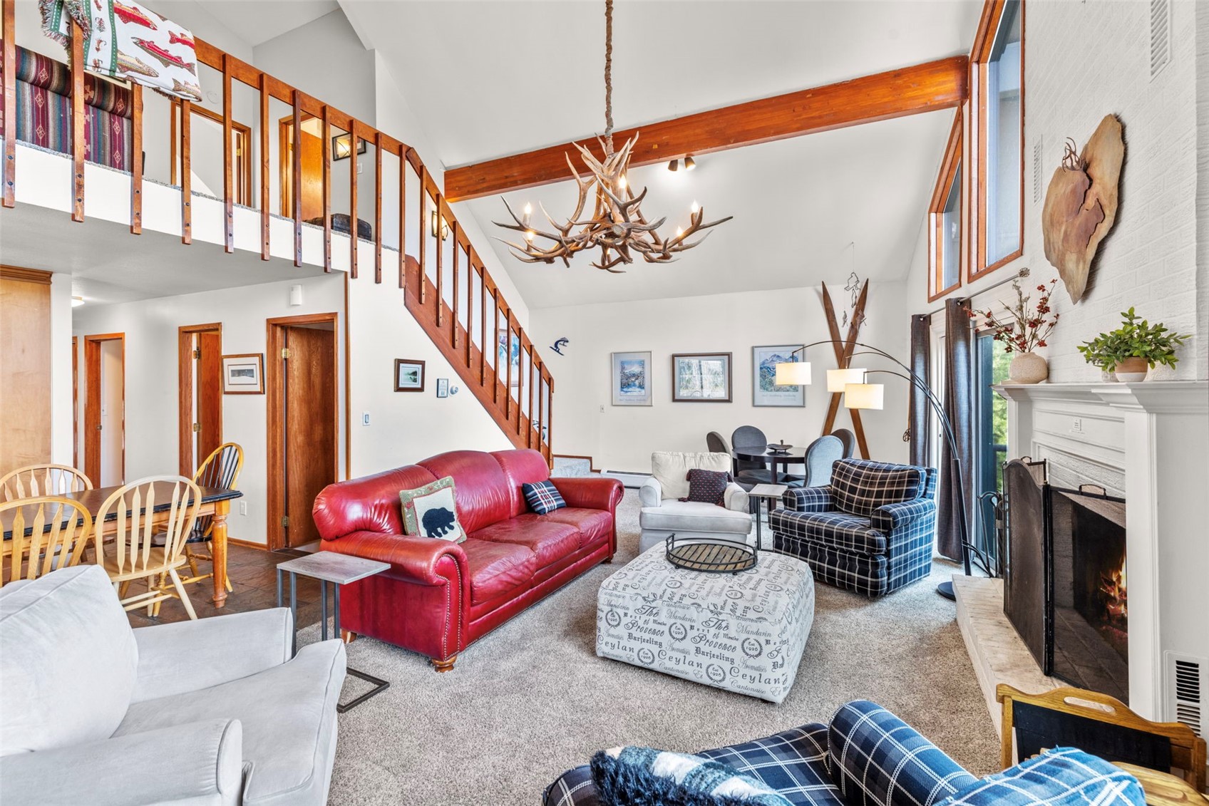 79 Forest Canyon Road Dillon, CO 80435 - Photo 7 of 50 Living room featuring high vaulted ceiling, beam ceiling, a notable chandelier, and carpet flooring