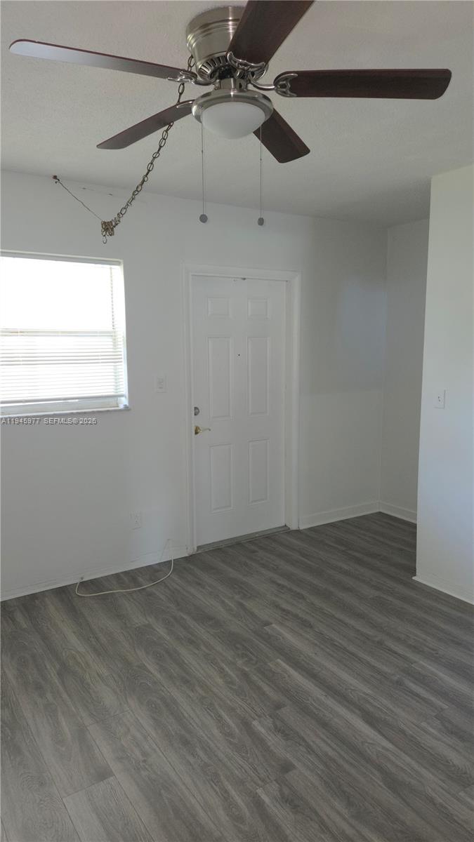 502-504 Phippen Waiters Road, Unit 3 Dania Beach, FL 33004 - Photo 14 of 22 a view of a room with wooden floor fan and windows