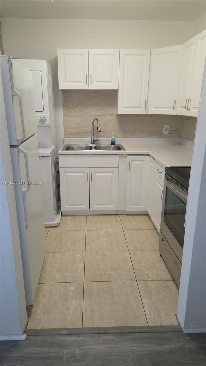 502-504 Phippen Waiters Road, Unit 3 Dania Beach, FL 33004 - Photo 16 of 22 a kitchen with white cabinets and white appliances