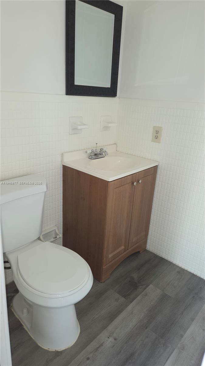 502-504 Phippen Waiters Road, Unit 3 Dania Beach, FL 33004 - Photo 2 of 22 a bathroom with a toilet a sink and mirror