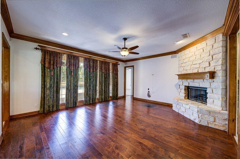 334 Farm To Market Road 2264 Decatur, TX 76234 - Photo 15 of 40 a view of an empty room with wooden floor fireplace and a window