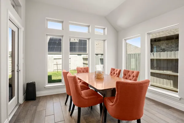 a dining room with furniture and wooden floor