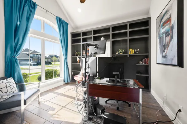 a view of a workspace with furniture and a window