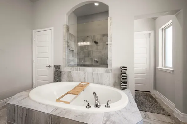 a bath tub sitting next to a white sink