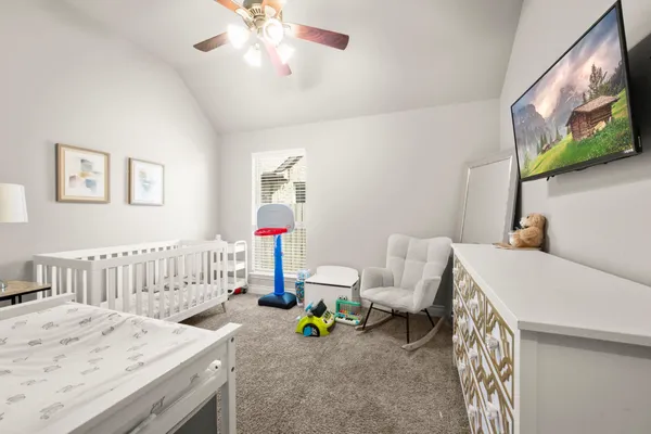 a bedroom with furniture and a chandelier