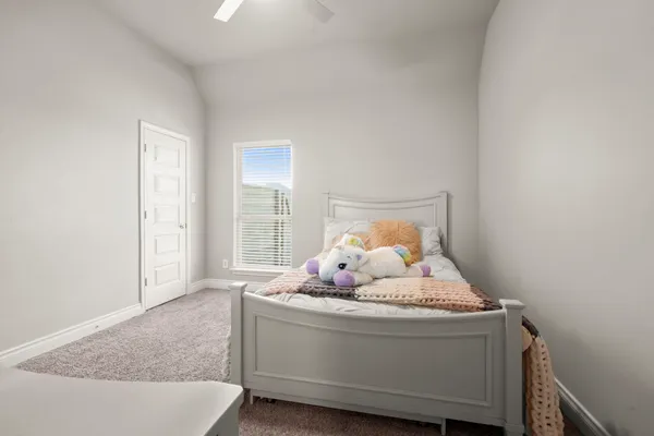 a room with a bed and window