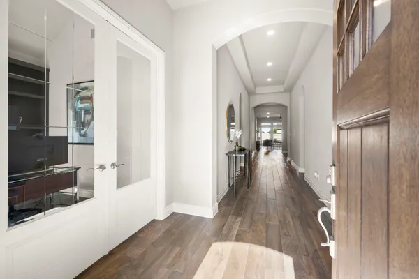 a view of a hallway view with wooden floor and staircase