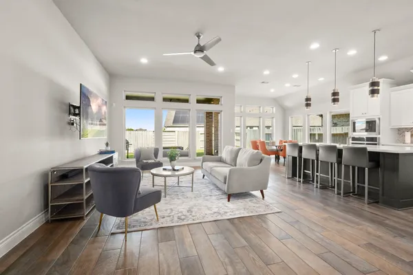 a living room with lots of furniture and kitchen view