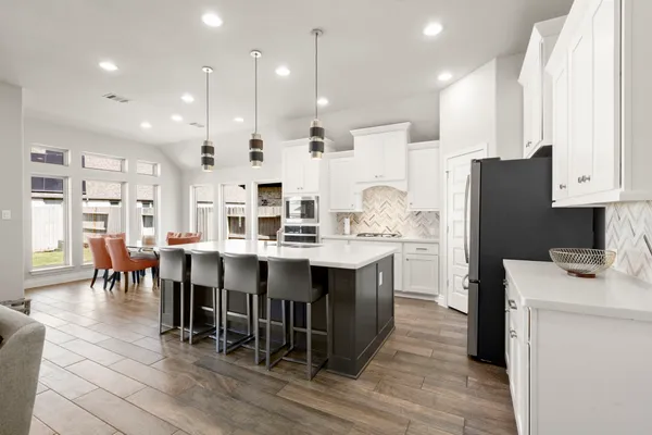 a large kitchen with stainless steel appliances kitchen island granite countertop a large center island attached withe living room