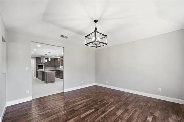 a view of a kitchen and wooden floor