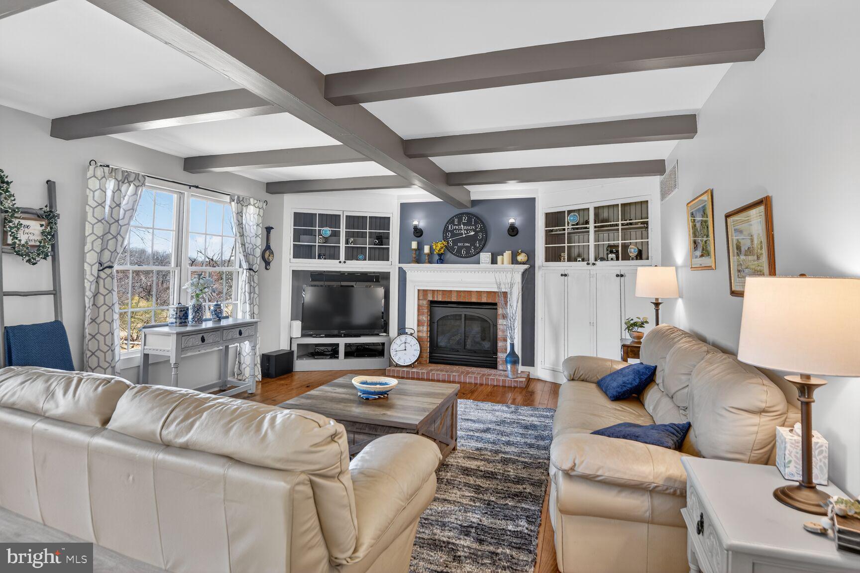 2338 Jim Kohler Road Eldersburg, MD 21784 - Photo 28 of 63 a living room with furniture large window and a fireplace