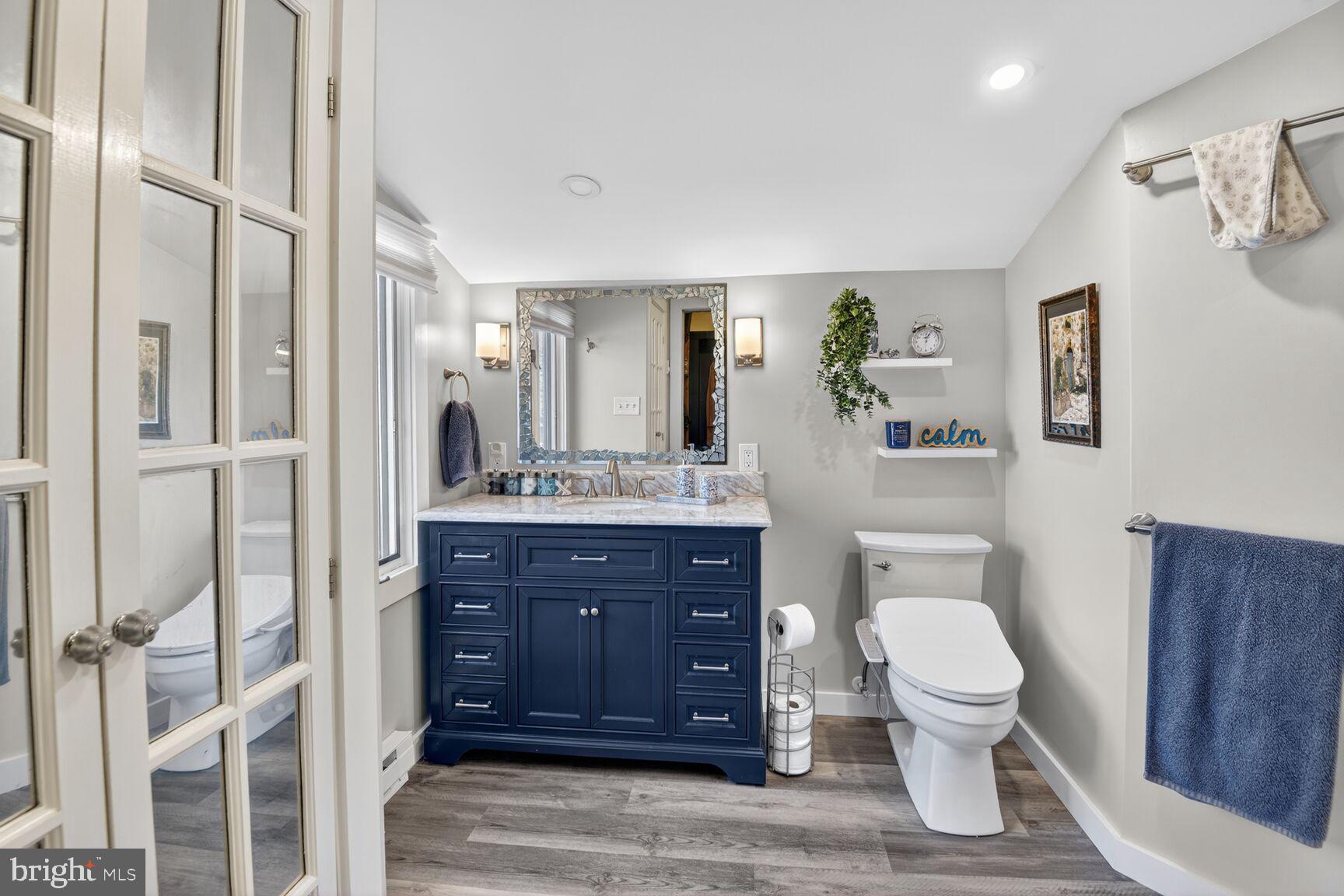 2338 Jim Kohler Road Eldersburg, MD 21784 - Photo 46 of 63 a bathroom with a toilet a sink and glass door