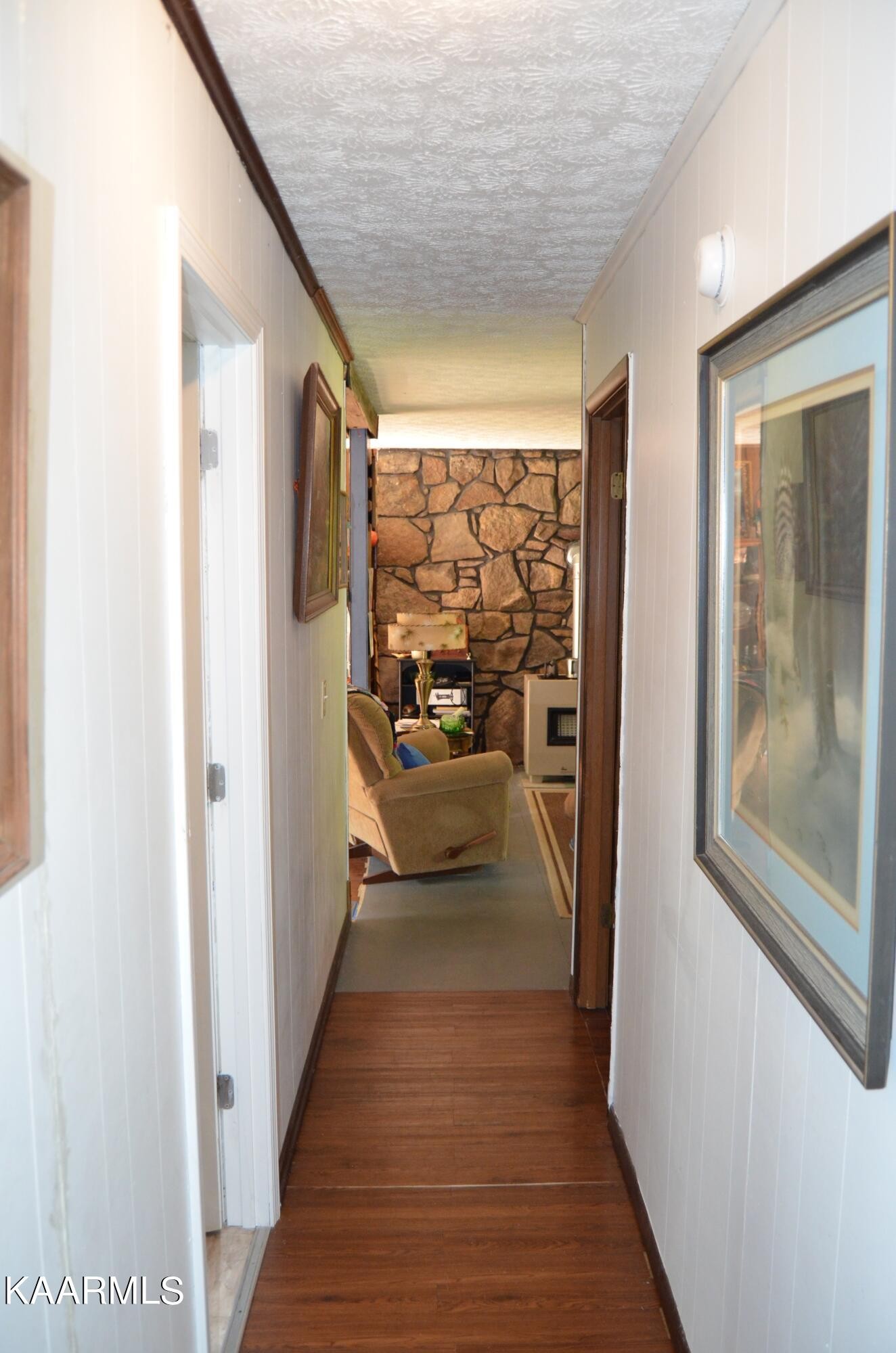 484 Kerrigan Road Crossville, TN 38555 - Photo 11 of 23 a view of a hallway with wooden floor and stairs