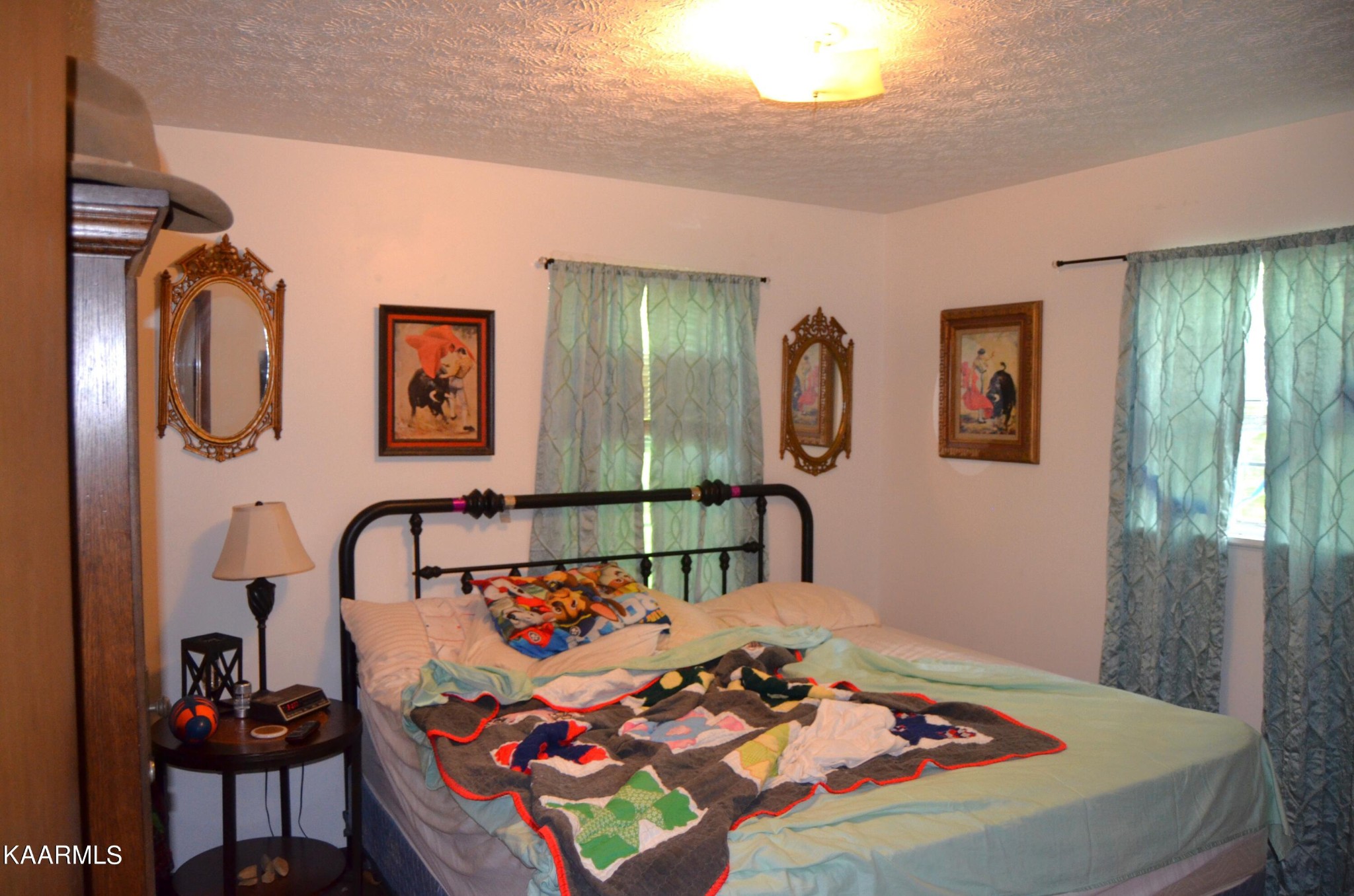 484 Kerrigan Road Crossville, TN 38555 - Photo 8 of 23 a bed sitting in a bedroom next to a window
