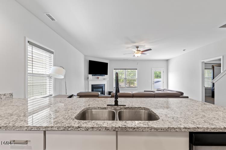 117 Boomer Street Benson, NC 27504 - Photo 11 of 31 a kitchen with granite countertop a sink and a window
