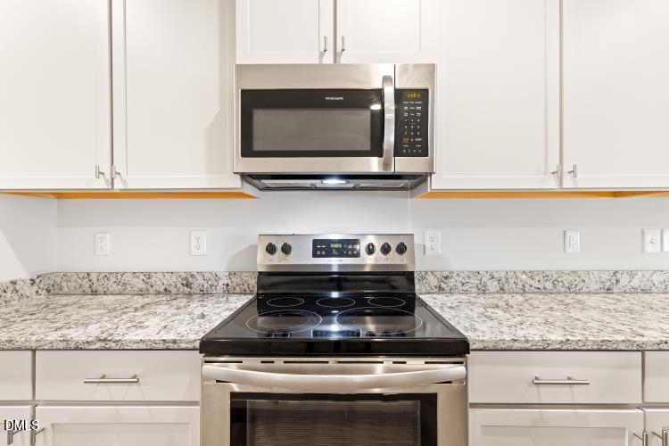 117 Boomer Street Benson, NC 27504 - Photo 12 of 31 a kitchen with granite countertop a stove and a microwave