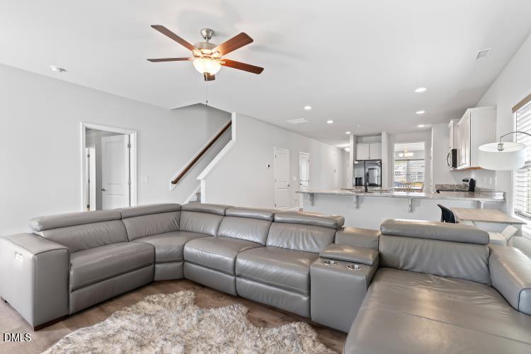 117 Boomer Street Benson, NC 27504 - Photo 14 of 31 a living room with furniture kitchen view and a chandelier