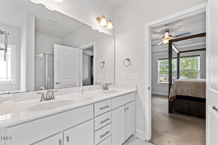 117 Boomer Street Benson, NC 27504 - Photo 20 of 31 a spacious en suite bathroom with a double vanity sink a large mirror and a shower