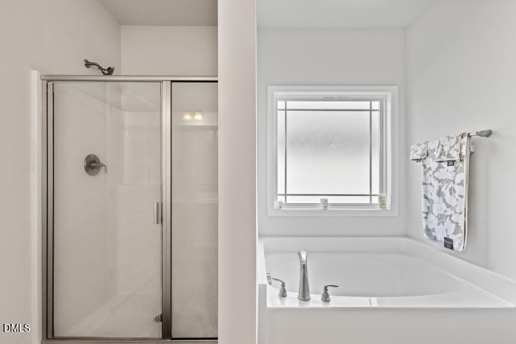 117 Boomer Street Benson, NC 27504 - Photo 21 of 31 a bathroom with a bathtub and a shower