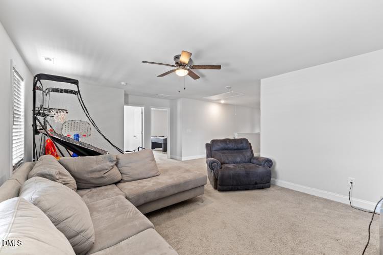 117 Boomer Street Benson, NC 27504 - Photo 22 of 31 a living room with furniture and a ceiling fan